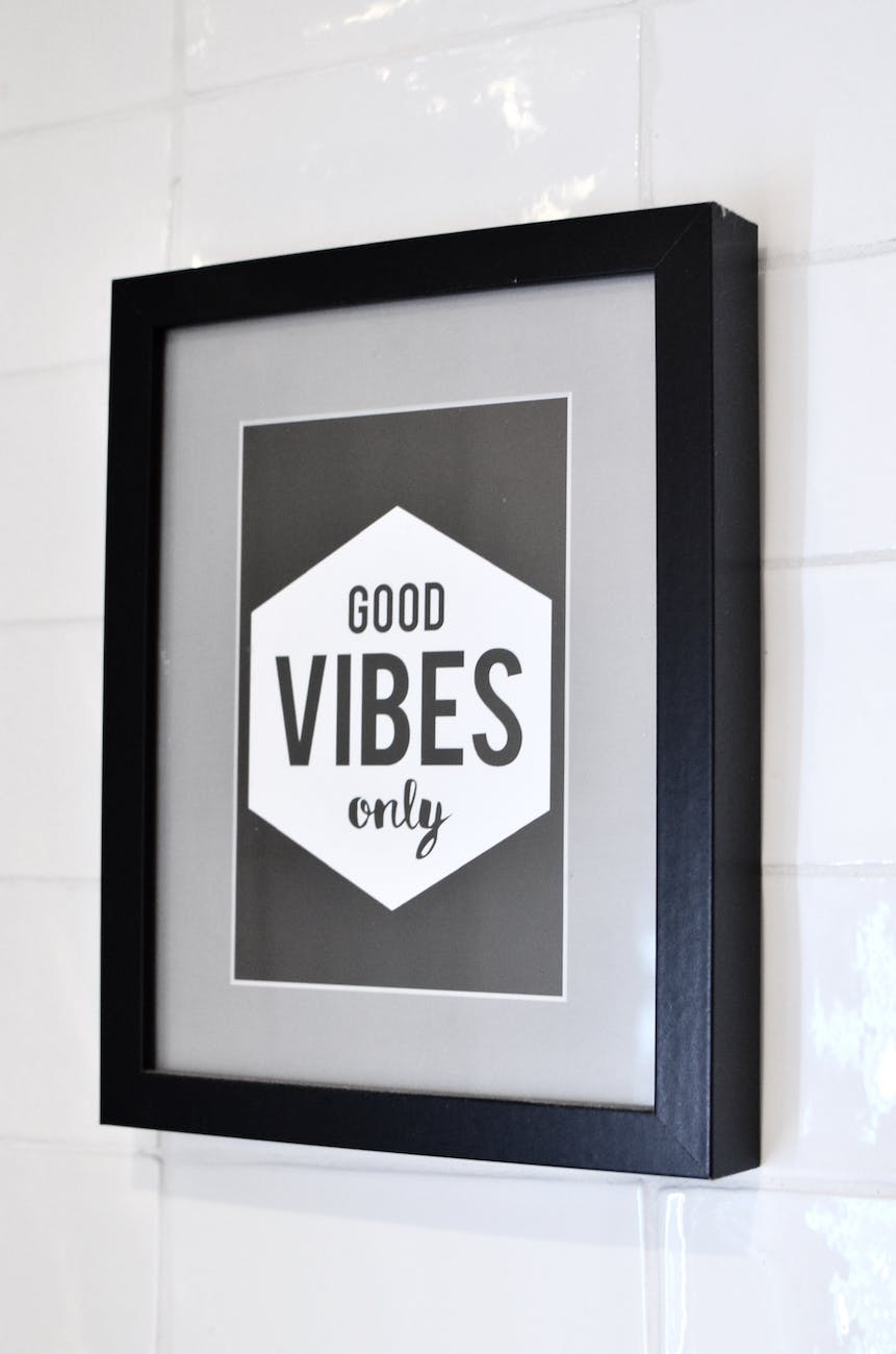 framed picture with inspirational text hanging on wall